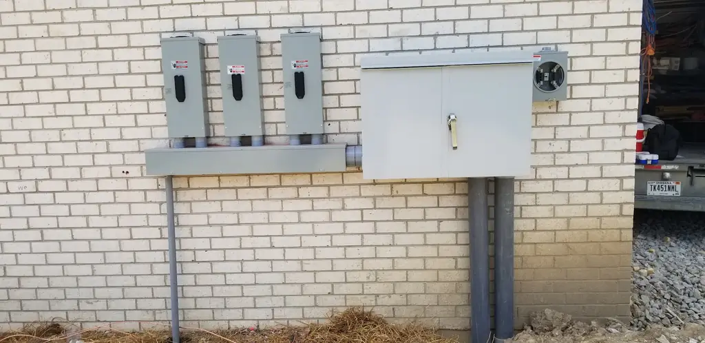 Burtner Electric electrical service and meter panel installed on a brick building